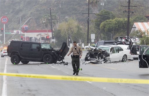 A Los Angeles County Sheriff's deputy investigates the scene of a collision involving three vehicles in Malibu, Calif. on Saturday, Feb. 7, 2015. Officials said former Olympian Bruce Jenner was a passenger in one of the cars involved in the...