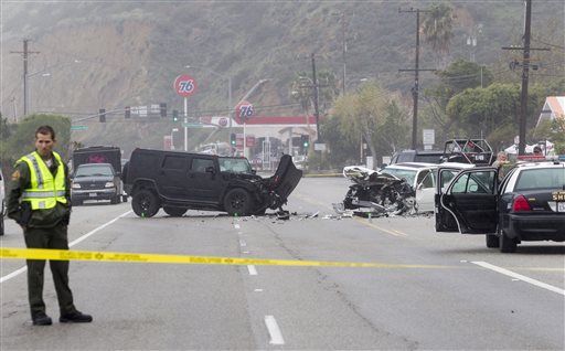 A Los Angeles County Sheriff's deputy guards the scene of a collision involving three vehicles in Malibu, Calif. on Saturday, Feb. 7, 2015. Officials said former Olympian Bruce Jenner was a passenger in one of the cars involved in the Pacific...