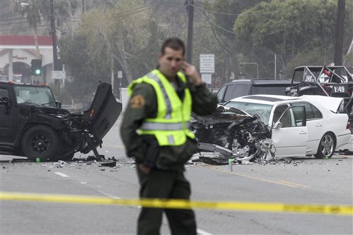 A Los Angeles County Sheriff's deputy guards the scene of a collision involving three vehicles in Malibu, Calif. on Saturday, Feb. 7, 2015. Officials said former Olympian Bruce Jenner was a passenger in one of the cars involved in the Pacific...