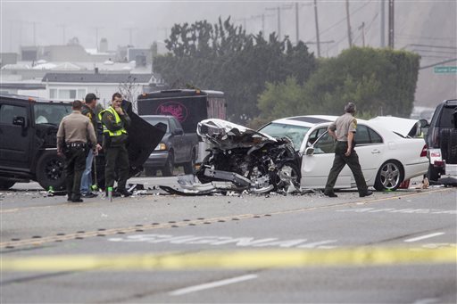 Los Angeles County Sheriff's deputies investigate the scene of a collision involving three vehicles in Malibu, Calif. on Saturday, Feb. 7, 2015. Officials said former Olympian Bruce Jenner was a passenger in one of the cars involved in the Pacific...