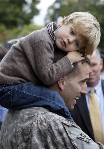 FILE - In this Wednesday, Sept. 30, 2009 file photo, Capt. Beau Biden carries his son Hunter, 3, on his shoulders after an official welcome home ceremony for members of the Delaware Army National Guard 261st Signal Brigade in Dover, Del. On...