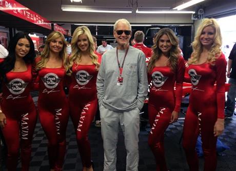 David Letterman, who ended his 33-year career as a late-night television host Wednesday, poses with models before the start of the Indianapolis 500 on Sunday, May 24, 2015, at the Indianapolis Motor Speedway in Indianapolis. Letterman's IndyCar...