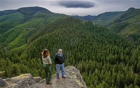 In this photo taken March 13, 2015, Steve Johnson, right, the acting district ranger of the Baker-Snoqualmie National Forest, stands with Mary Coughlin, left, of the U.S. Forest Service, overlooking an area near Greenwater, Wash. that would...