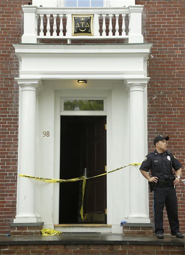 A Tufts University law enforcement official stands outside the Delta Tau Delta fraternity house, in Somerville, Mass., Sunday, May 31, 2015, near the Tufts University, Medford, Mass., campus. Two people were stabbed at the fraternity house early...