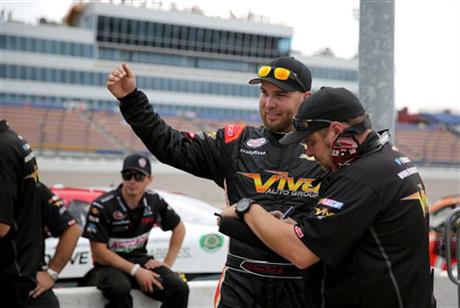 Jamie Dick talks with members of his crew after his first qualifying run for the NASCAR Xfinity Series auto race at the Iowa Speedway, Saturday, May 16, 2015, in Newton, Iowa. During the end of the morning practice run Dick had a piece of lead...