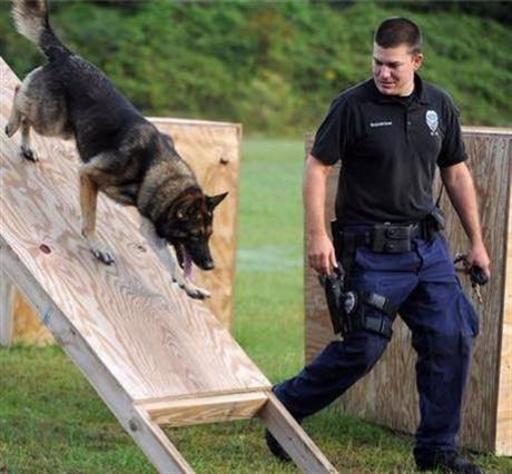 In this undated photo released by the Hattiesburg Police Department, Officer Benjamin Deen participates in K-9 training at the police academy in Hattiesburg, Miss. Officer Deen and Officer Liquori Tate were fatally shot during a traffic stop,...