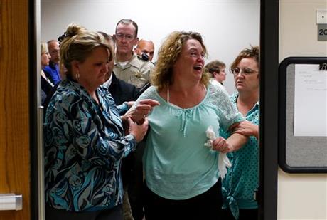 Meagan Grunwald's mother Tori Grunwald cries as she is helped out of the courtroom after the jury found the Utah teenager guilty in a 50-mile crime spree that left one sheriff's deputy dead and another wounded, at the Fourth District Court in...