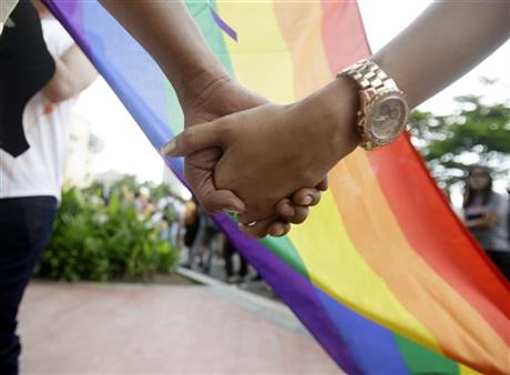 Filipino LGBTs (Lesbians Gays Bisexual and Transgenders) hold hands as they gather for a Gay Pride rally Saturday, June 27, 2015 in Mania, Philippines to push for LGBT rights and to celebrate the U.S. Supreme Court decision recognizing gay...