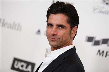 FILE - This April 25, 2015, file photo shows actor John Stamos arriving at the 4th Annual Reel Stories, Real Lives Benefit in Los Angeles. Stamos has been arrested and cited with driving under the influence in Beverly Hills. Beverly Hills police...