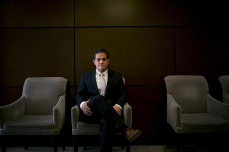 Attorney Chris Markelz, who is in the legal incubator program run by Whittier Law School, poses for photos in the lobby area of his office, Wednesday, June 3, 2015, in Santa Ana, Calif. The incubators give new lawyers practical experience while...