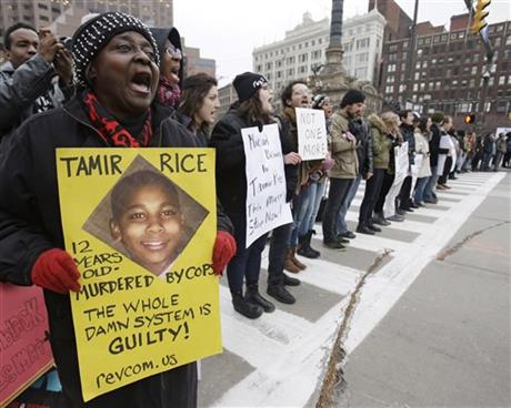 FILE- In this Nov. 25, 2014, file photo, demonstrators block Public Square in Cleveland, during a protest over the police shooting of 12-year-old Tamir Rice. A judge has ruled that evidence exists to charge two police officers in the fatal...