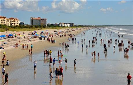 A crowd at Cocoa Beach, Fla. watches the launch of the SpaceX Falcon 9 rocket and Dragon spacecraft, which broke apart shortly after liftoff from the Cape Canaveral Air Force Station, Sunday, June 28, 2015. The rocket was carrying supplies to the...