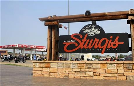 FILE - In this Aug. 4, 2014 file photo, bikers ride past the city's welcome sign in Sturgis, S.D., during opening day of the annual Sturgis Motorcycle Rally. Preparations are under way for the landmark 75th anniversary rally beginning Monday, Aug....