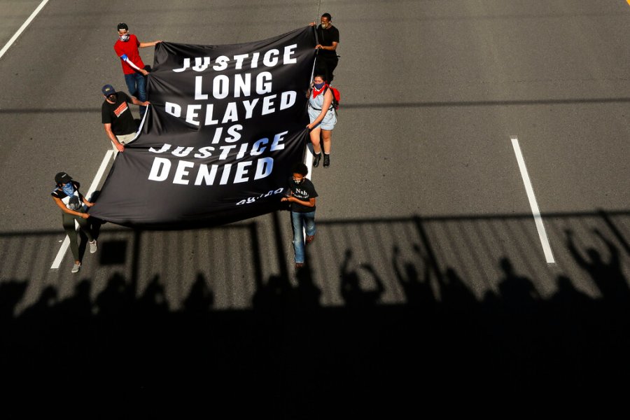 Demonstrators march along an interstate in Minneapolis. (AP Photo/Julio Cortez)