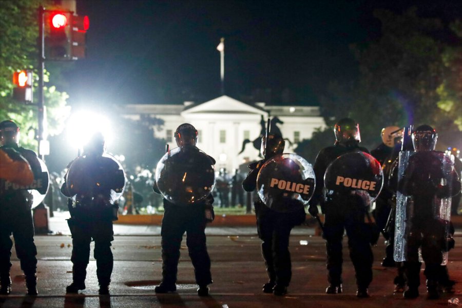 Police form a line on H Street as demonstrators gather to protest near the White House in Washington, DC. (AP Photo/Alex Brandon)