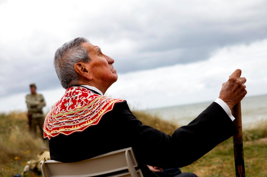 World War II D-Day veteran and Penobscot Elder from Maine, Charles Norman Shay participates in a Native American ceremony  overlooking Omaha Beach in Saint-Laurent-sur-Mer, Normandy, France, Friday, June 5, 2020. Saturday's anniversary of D-Day will be one of the loneliest remembrances ever, as the coronavirus pandemic is keeping almost everyone away, from government leaders to frail veterans who might not get another chance for a final farewell to their unlucky comrades. (AP Photo/Virginia Mayo)