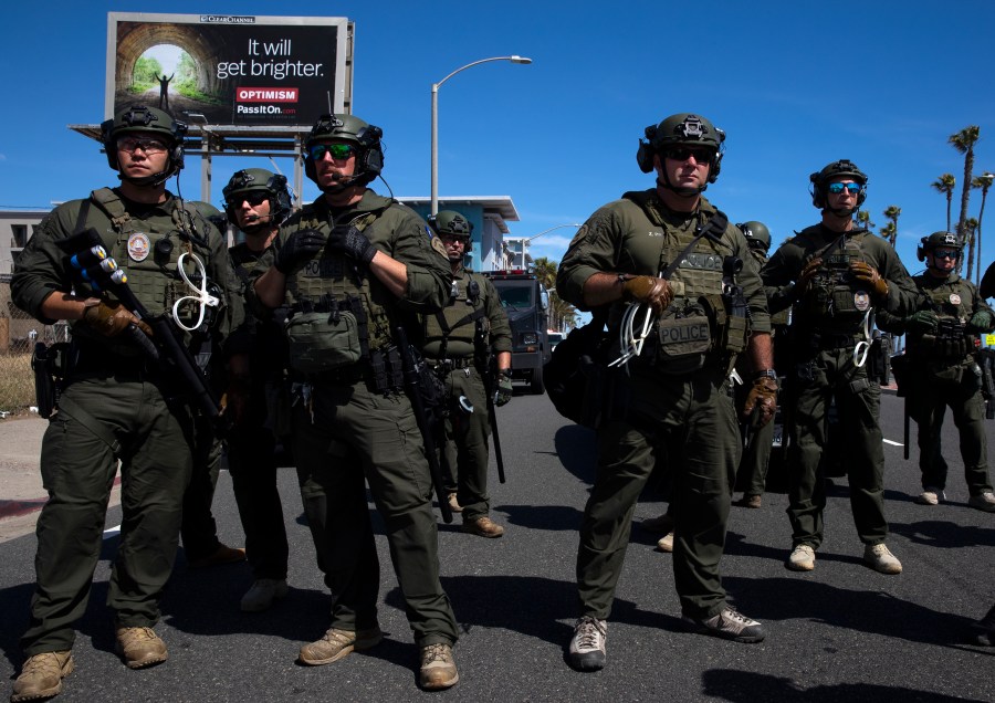 Huntington Beach SWAT team members stand ready for protesters after violent demonstrations in response to George Floyd's death on May 31, 2020 in Huntington Beach, California. (Photo by Brent Stirton/Getty Images)