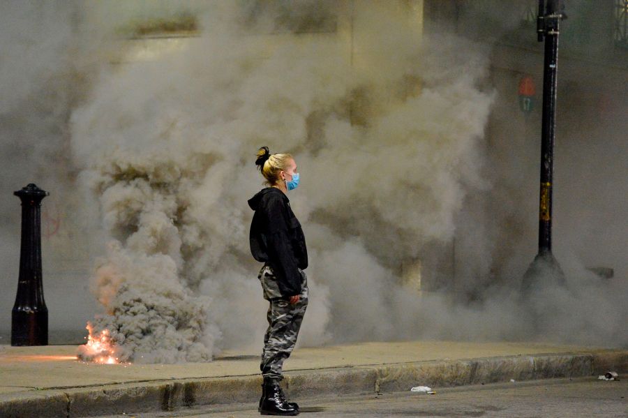 A protester faces police (out of frame) during clashes after a demonstration over the death of George Floyd in Boston. (Photo by JOSEPH PREZIOSO/AFP via Getty Images)