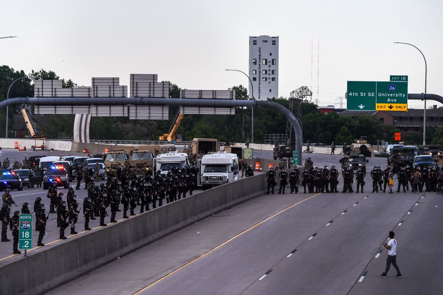 A demonstrator stands in front of the police line during a protest in Minneapolis, Minnesota.(Photo by CHANDAN KHANNA/AFP via Getty Images)