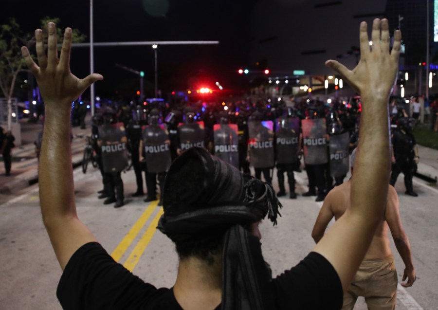 Police watch as demonstrators block a roadway while protesting against police brutality and the death of George Floyd in Miami, Florida. (Photo by Joe Raedle/Getty Images)