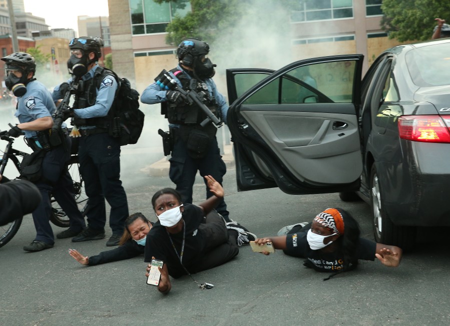 Police remove people from a vehicle during a protest against police brutality and the death of George Floyd in Minneapolis, Minnesota. (Photo by Scott Olson/Getty Images)