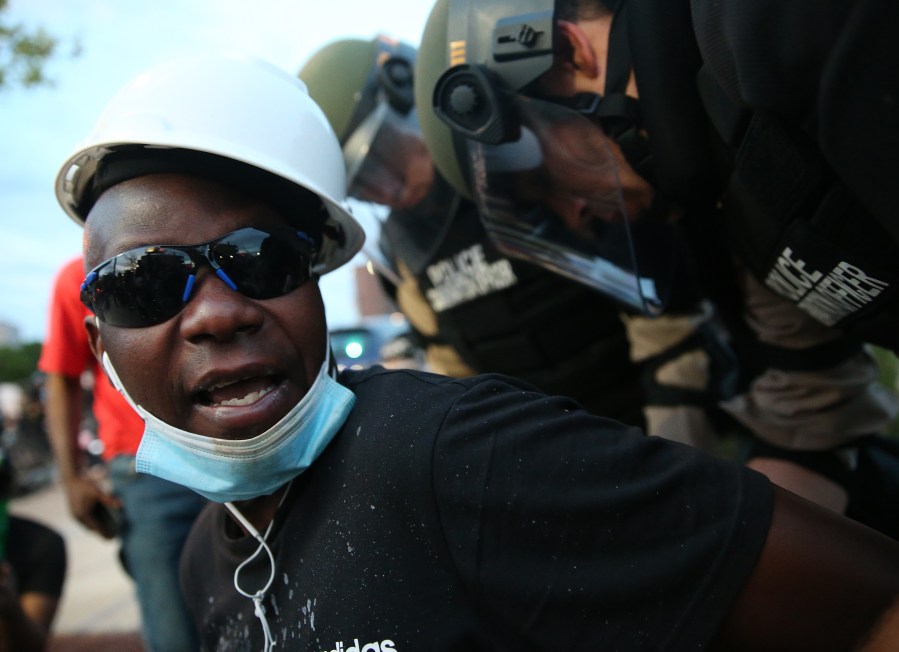 A demonstrator is arrested during a protest against police brutality and the death of George Floyd in Minneapolis, Minnesota. (Photo by Scott Olson/Getty Images)