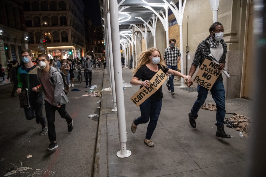 Demonstrators flee after a march turned violent in Manhattan, New York City. (Photo by John Moore/Getty Images)