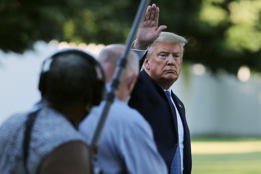 President Trump waves to journalists as he returns to the White House after posing for photographs in front of St. John's Episcopal Church. (Photo by Chip Somodevilla/Getty Images)