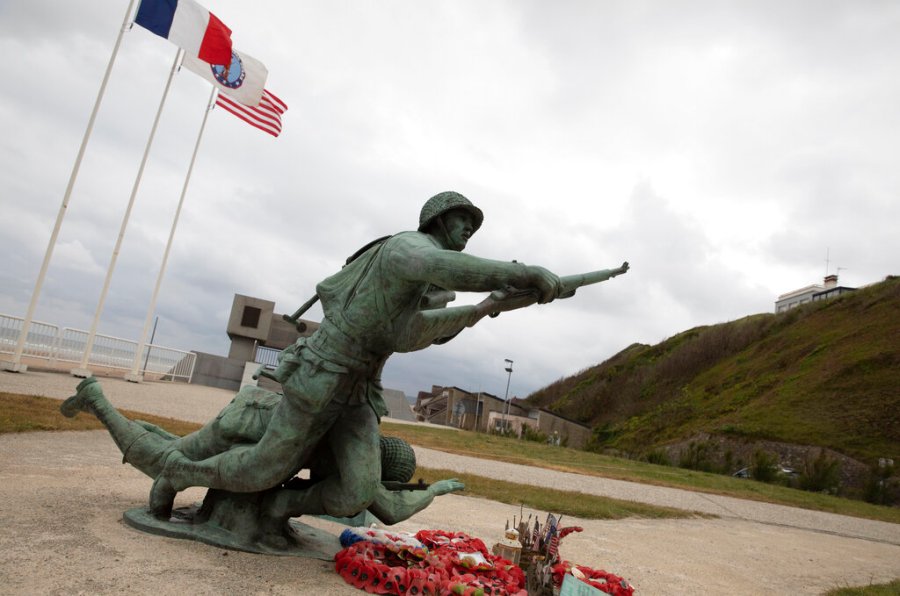 In this photo taken on Thursday, June 4, 2020, wreaths and flags sit in front of the Ever Forward memorial near Omaha Beach, in Vierville-sur-Mer, Normandy, France. In sharp contrast to the 75th anniversary of D-Day, this year's 76th will be one of the loneliest remembrances ever, as the coronavirus pandemic is keeping nearly everyone from traveling. (AP Photo/Virginia Mayo)