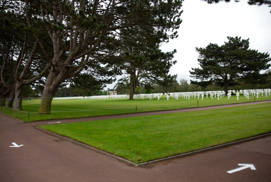 Arrows are painted on the ground to guide visitors to walk only one way, to prevent the spread of the coronavirus, at the Normandy American Cemetery in Colleville-sur-Mer, Normandy, France. In sharp contrast to the 75th anniversary of D-Day, this year's 76th will be one of the loneliest remembrances ever, as the coronavirus pandemic is keeping nearly everyone from traveling. (AP Photo/Virginia Mayo)