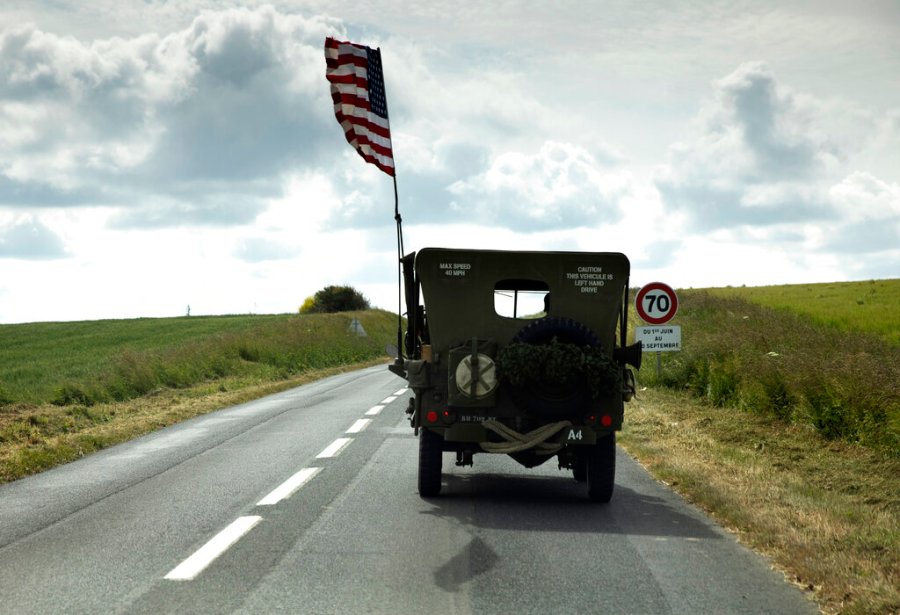 A US flag flies on the back of a WWII era US Army Jeep in Grandcamp Maisy, Normandy, France on Thursday, June 4, 2020. In sharp contrast to the 75th anniversary of D-Day, this year's 76th will be one of the loneliest remembrances ever, as the coronavirus pandemic is keeping nearly everyone from traveling. (AP Photo/Virginia Mayo)