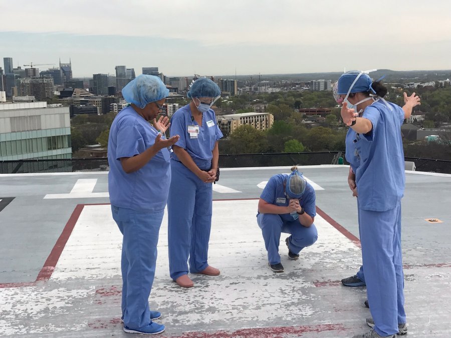 Staff prays on Vanderbilt's helipad