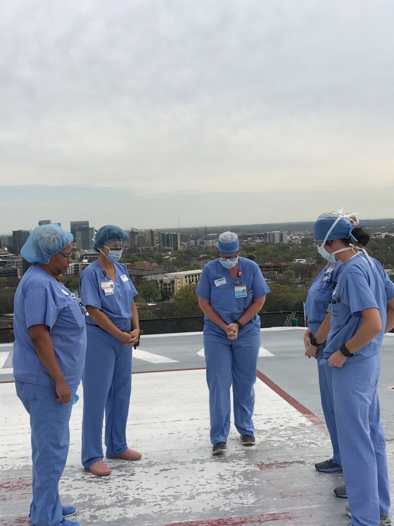 Staff prays on Vanderbilt's helipad